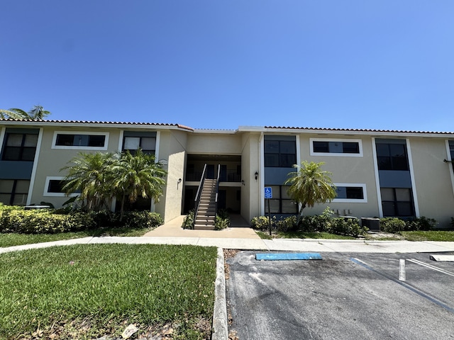 1453 Lake Crystal Dr Unit H, West Palm Beach, FL 33411 - view of building exterior featuring uncovered parking and stairs
