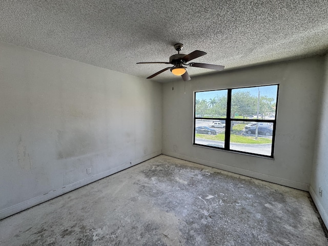 1453 Lake Crystal Dr Unit H, West Palm Beach, FL 33411 - spare room featuring concrete floors, a ceiling fan, a textured ceiling, and baseboards