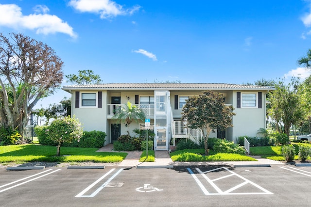 6 Stratford Dr E Unit D, Boynton Beach, FL 33436 - view of property featuring uncovered parking and stairway