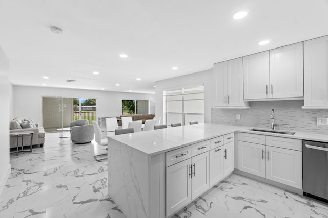 6 Stratford Dr E Unit D, Boynton Beach, FL 33436 - kitchen with a sink, stainless steel dishwasher, recessed lighting, light marble finish flooring, and a peninsula