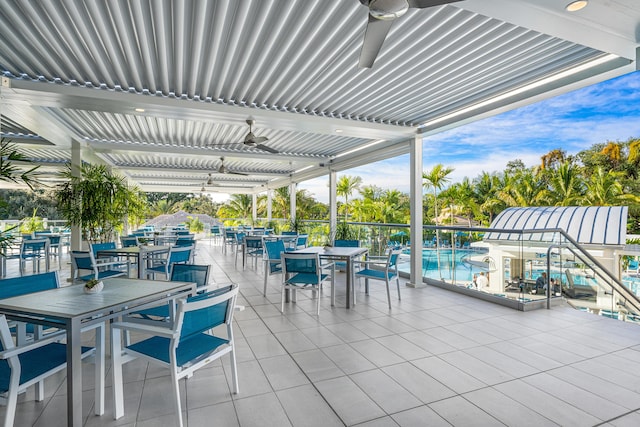 6 Stratford Dr E Unit D, Boynton Beach, FL 33436 - view of patio featuring outdoor dining area, a ceiling fan, and an outdoor pool