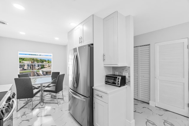 6 Stratford Dr E Unit D, Boynton Beach, FL 33436 - kitchen with stainless steel appliances, recessed lighting, light countertops, light marble finish flooring, and white cabinets