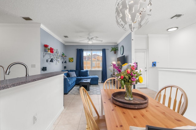 2879 Crestwood Ter Unit 1202, Margate, FL 33063 - dining space with light tile patterned floors, ornamental molding, a ceiling fan, baseboards, and a textured ceiling