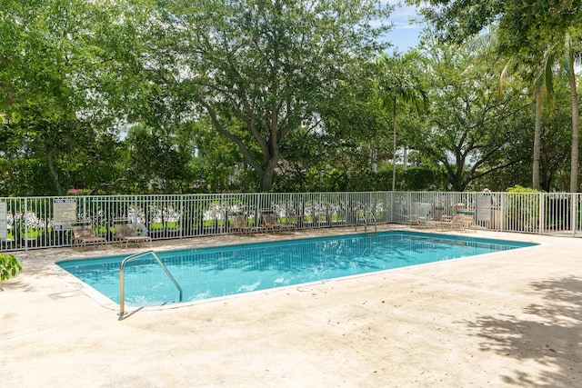 2879 Crestwood Ter Unit 1202, Margate, FL 33063 - community pool with a patio, fence, and view of scattered trees