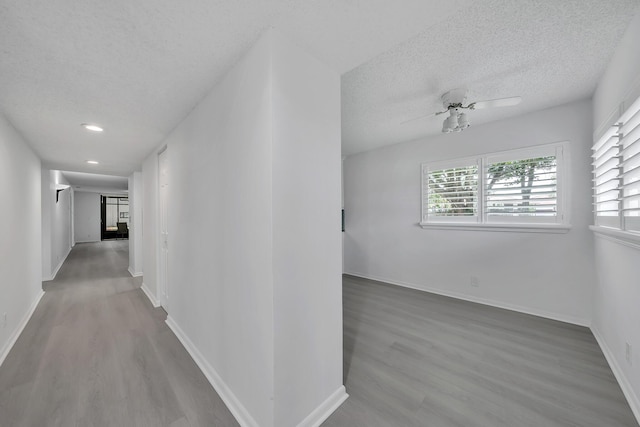 15244 Lakes Of Delray Blvd Unit 112, Delray Beach, FL 33484 - hall with a textured ceiling, wood finished floors, baseboards, and recessed lighting