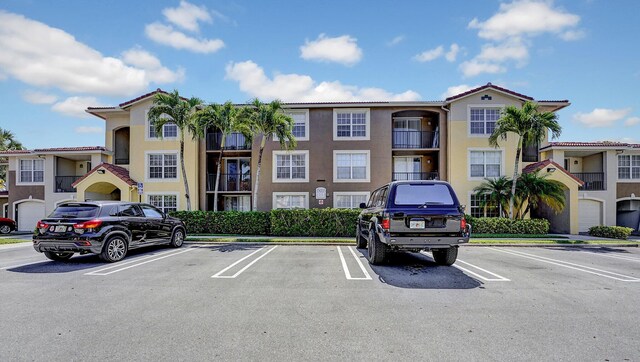 15035 Michelangelo Blvd Unit 106, Delray Beach, FL 33446 - view of property featuring uncovered parking
