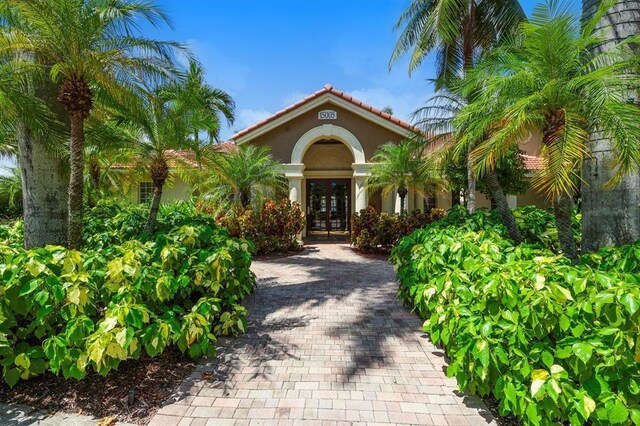 15035 Michelangelo Blvd Unit 106, Delray Beach, FL 33446 - entrance to property featuring french doors, stucco siding, and a tiled roof