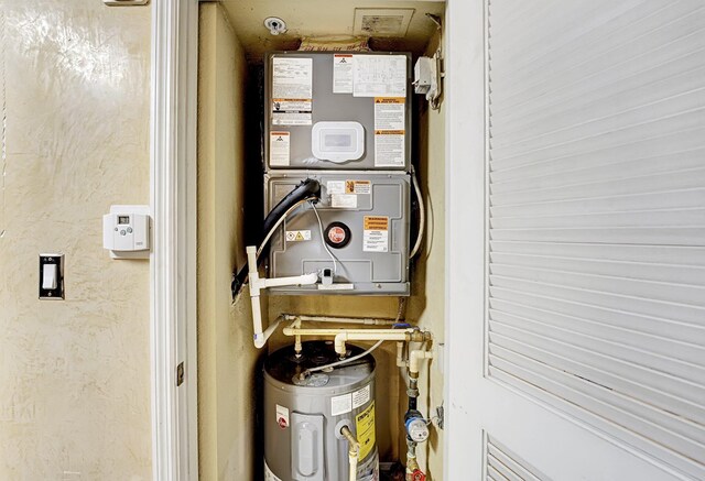 15035 Michelangelo Blvd Unit 106, Delray Beach, FL 33446 - utility room with electric water heater