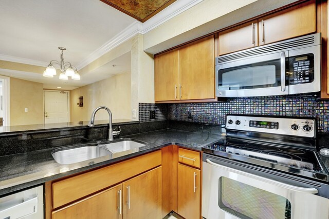 15035 Michelangelo Blvd Unit 106, Delray Beach, FL 33446 - kitchen featuring appliances with stainless steel finishes, a sink, crown molding, a chandelier, and tasteful backsplash