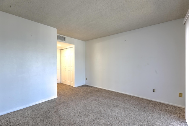 1604 SE Green Acres Cir Unit T201, Port Saint Lucie, FL 34952 - spare room featuring carpet floors, a textured ceiling, and baseboards