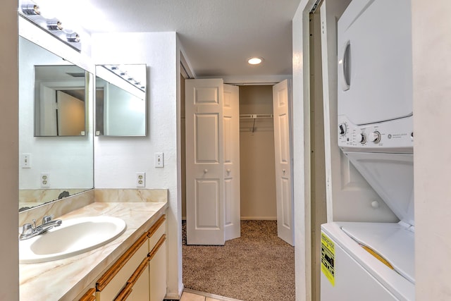 1604 SE Green Acres Cir Unit T201, Port Saint Lucie, FL 34952 - bathroom featuring stacked washer / drying machine, vanity, a spacious closet, and recessed lighting
