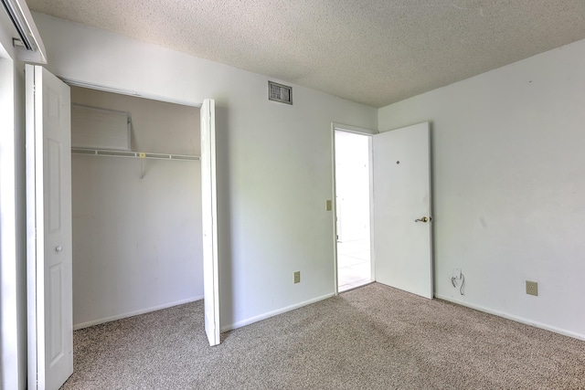 1604 SE Green Acres Cir Unit T201, Port Saint Lucie, FL 34952 - unfurnished bedroom featuring carpet, a closet, a textured ceiling, and baseboards