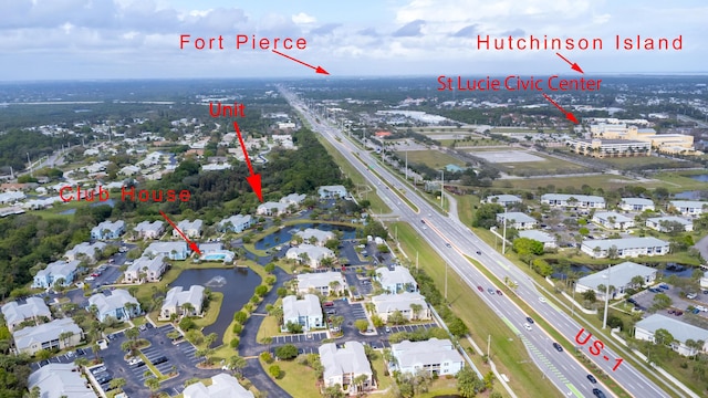 1604 SE Green Acres Cir Unit T201, Port Saint Lucie, FL 34952 - aerial view of property and surrounding area with a highway, nearby suburban area, and a large body of water