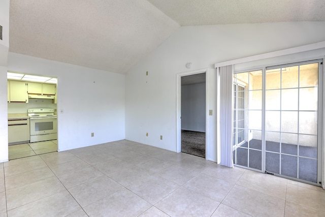1604 SE Green Acres Cir Unit T201, Port Saint Lucie, FL 34952 - empty room featuring vaulted ceiling and light tile patterned flooring