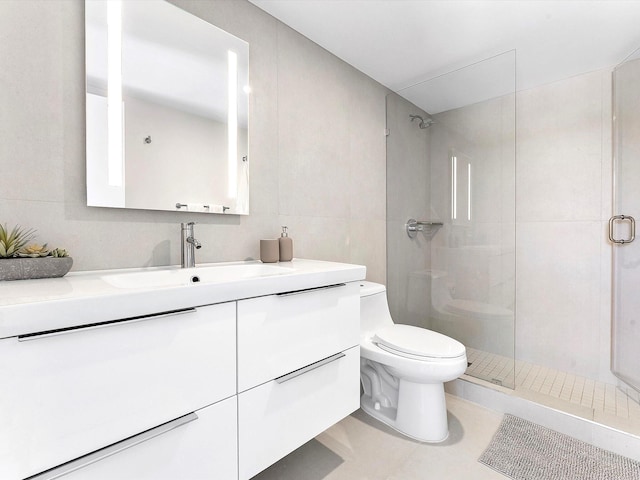 2780 S Ocean Blvd Unit 311, Palm Beach, FL 33480 - full bath featuring toilet, a stall shower, tile walls, vanity, and tile patterned flooring