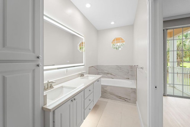 122 Ashley Ct, Jupiter, FL 33458 - bathroom featuring a garden tub, double vanity, tile patterned floors, and recessed lighting
