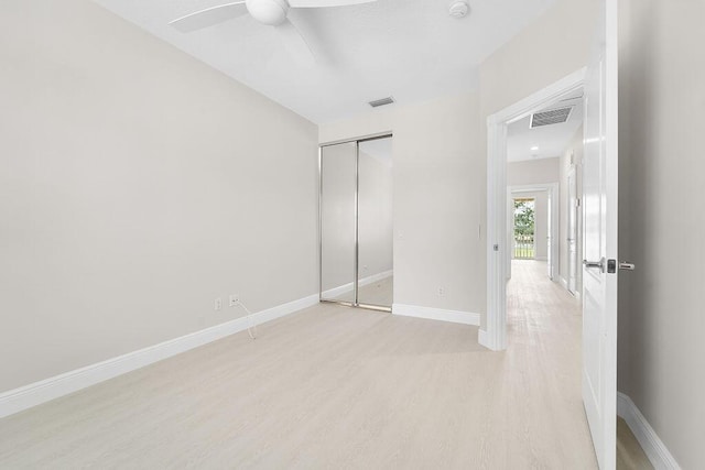 122 Ashley Ct, Jupiter, FL 33458 - unfurnished bedroom featuring light wood-type flooring, baseboards, a closet, and a ceiling fan