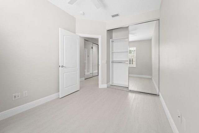 122 Ashley Ct, Jupiter, FL 33458 - unfurnished bedroom with light wood-type flooring, a closet, baseboards, and ceiling fan