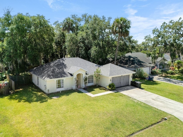 2389 SW Caballero St, Port Saint Lucie, FL 34953 - single story home featuring concrete driveway, a garage, a shingled roof, and stucco siding
