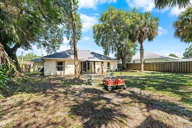 2389 SW Caballero St, Port Saint Lucie, FL 34953 - rear view of house with stucco siding