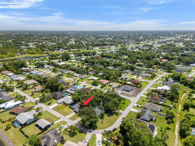 2389 SW Caballero St, Port Saint Lucie, FL 34953 - aerial view of property and surrounding area with a large body of water and nearby suburban area