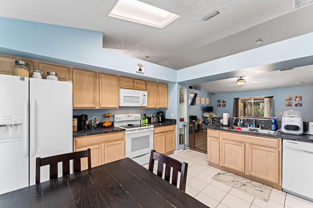 2389 SW Caballero St, Port Saint Lucie, FL 34953 - kitchen with white appliances, a sink, dark countertops, and light brown cabinets