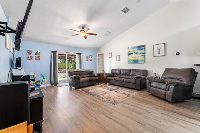 2389 SW Caballero St, Port Saint Lucie, FL 34953 - living room with a ceiling fan, vaulted ceiling, wood finished floors, a textured ceiling, and baseboards