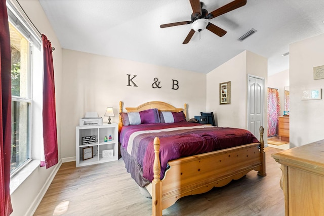 2389 SW Caballero St, Port Saint Lucie, FL 34953 - bedroom featuring lofted ceiling, wood finished floors, baseboards, connected bathroom, and ceiling fan