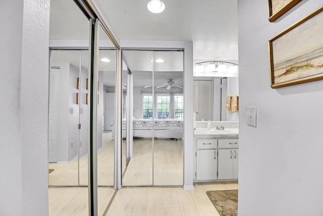 1673 SE Green Acres Cir Unit Nn-202, Port Saint Lucie, FL 34952 - bathroom featuring a ceiling fan, vanity, recessed lighting, and wood finished floors