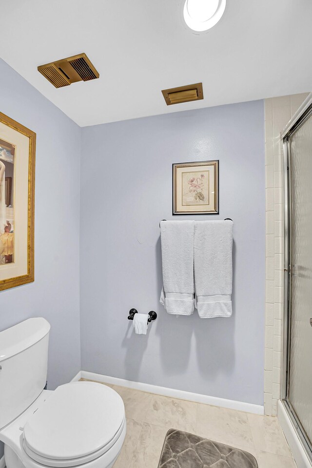1673 SE Green Acres Cir Unit Nn-202, Port Saint Lucie, FL 34952 - bathroom featuring toilet, an enclosed shower, and baseboards