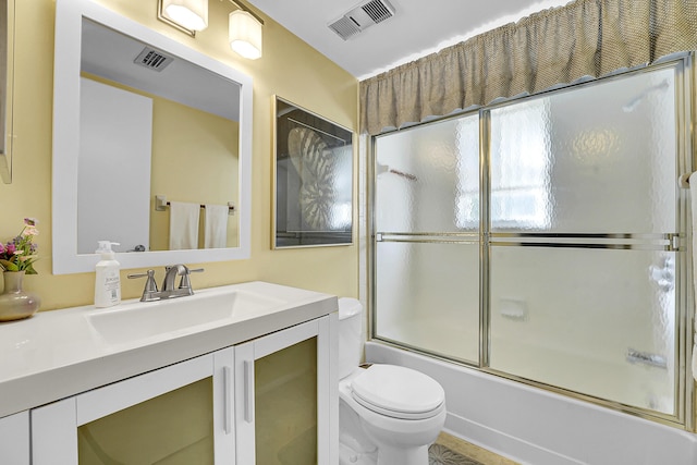 1673 SE Green Acres Cir Unit Nn-202, Port Saint Lucie, FL 34952 - bathroom featuring toilet, enclosed tub / shower combo, and vanity