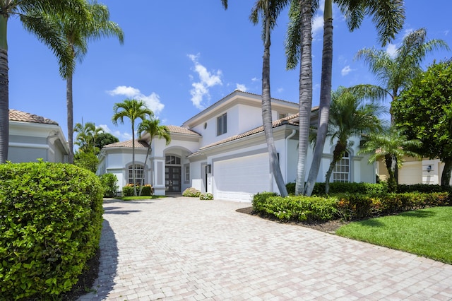 157 Esperanza Way, Palm Beach Gardens, FL 33418 - mediterranean / spanish-style house featuring stucco siding, decorative driveway, and a garage