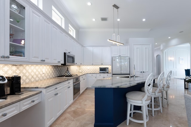 157 Esperanza Way, Palm Beach Gardens, FL 33418 - kitchen featuring stainless steel appliances, arched walkways, crown molding, white cabinetry, and light stone countertops