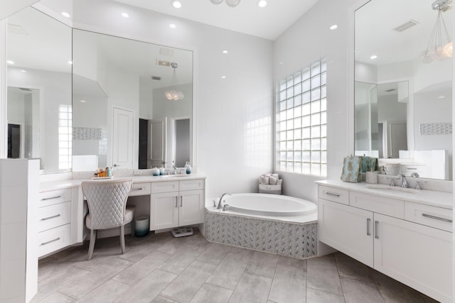 157 Esperanza Way, Palm Beach Gardens, FL 33418 - full bathroom with a garden tub, two vanities, a towering ceiling, and recessed lighting