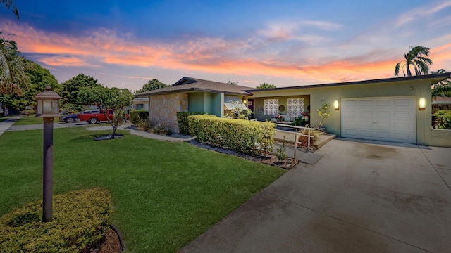 1630 40th St, West Palm Beach, FL 33407 - mid-century modern home with driveway, an attached garage, a lawn, stucco siding, and stone siding