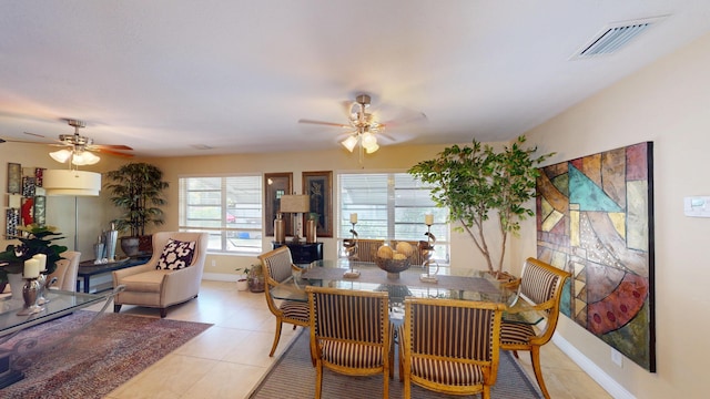 dining area with ceiling fan, light tile patterned flooring, and baseboards