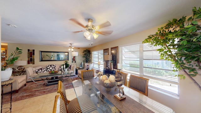 dining room with healthy amount of natural light, light tile patterned floors, and ceiling fan
