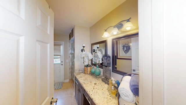 full bathroom with vanity, tile patterned flooring, a shower with shower door, and baseboards