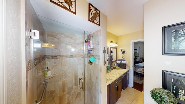 ensuite bathroom featuring a stall shower and vanity