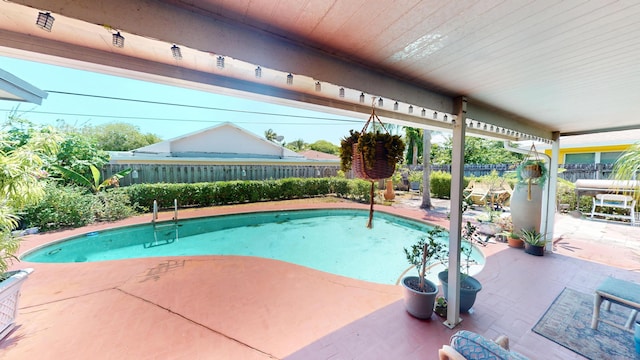 view of pool featuring a patio area and a fenced backyard