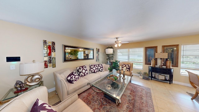 living room featuring plenty of natural light, baseboards, light tile patterned floors, and a ceiling fan