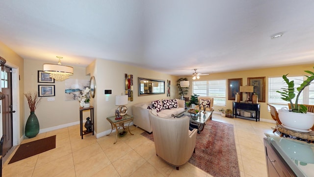 living room with light tile patterned floors, baseboards, and a ceiling fan
