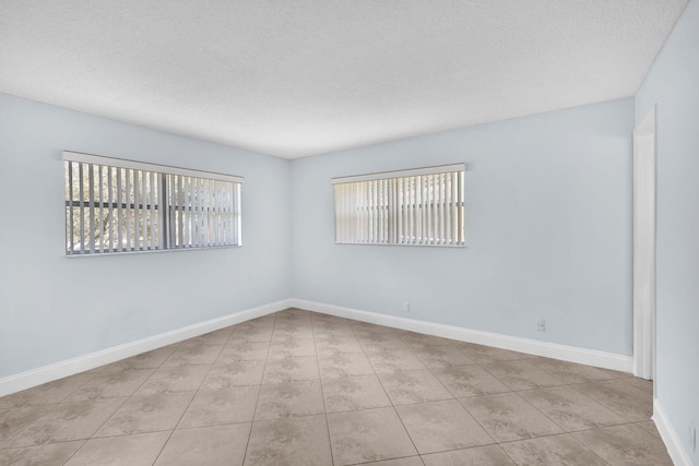 8826 W Mcnab Rd Unit 201, Tamarac, FL 33321 - unfurnished room with a textured ceiling, tile patterned flooring, and baseboards