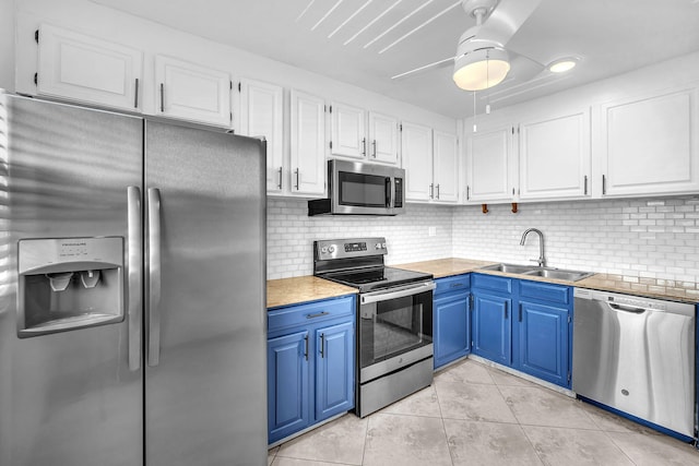 8826 W Mcnab Rd Unit 201, Tamarac, FL 33321 - kitchen featuring stainless steel appliances, a sink, blue cabinets, white cabinetry, and light tile patterned floors