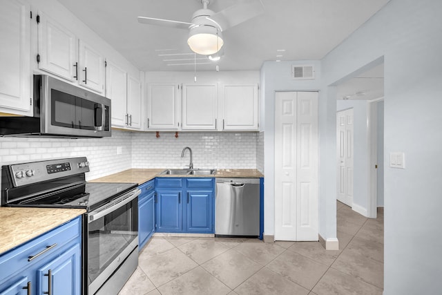 8826 W Mcnab Rd Unit 201, Tamarac, FL 33321 - kitchen with appliances with stainless steel finishes, a sink, light tile patterned floors, white cabinets, and blue cabinets