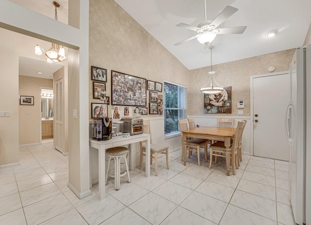 7043 Summer Tree Dr, Boynton Beach, FL 33437 - dining area with vaulted ceiling, a ceiling fan, a chandelier, light marble finish flooring, and baseboards