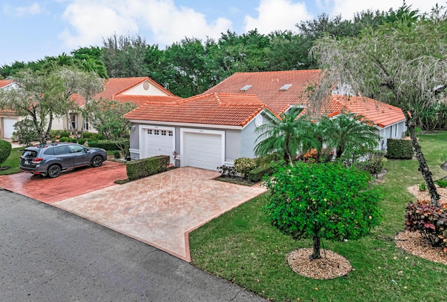 7043 Summer Tree Dr, Boynton Beach, FL 33437 - mediterranean / spanish home with an attached garage, a tile roof, stucco siding, driveway, and a front lawn
