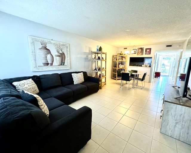 living area with light tile patterned flooring and a textured ceiling