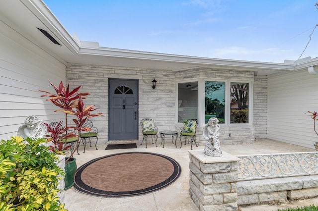 1101 SE 7th Ct, Deerfield Beach, FL 33441 - view of exterior entry with a porch and stone siding
