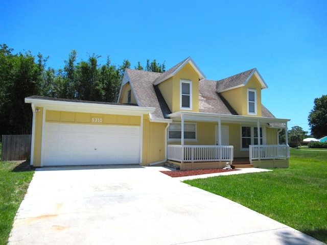 5310 Palm Dr, Fort Pierce, FL 34982 - view of front of house with a porch, a shingled roof, an attached garage, a front lawn, and concrete driveway